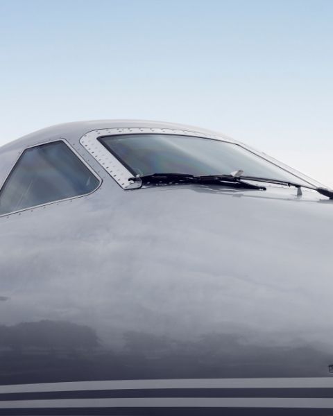 a close up shot of the cockpit of a plane taken from the outside