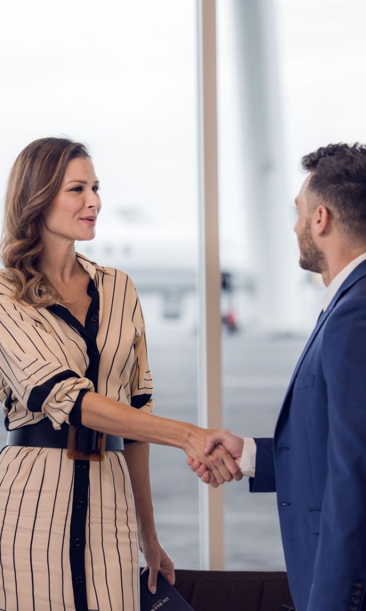 a well-dressed person getting off a plane