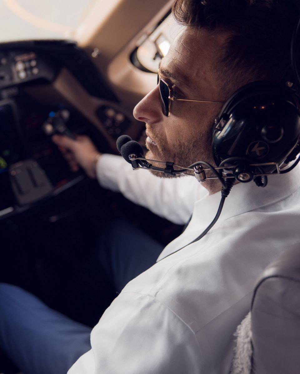 a pilot sitting in the plane cockpit